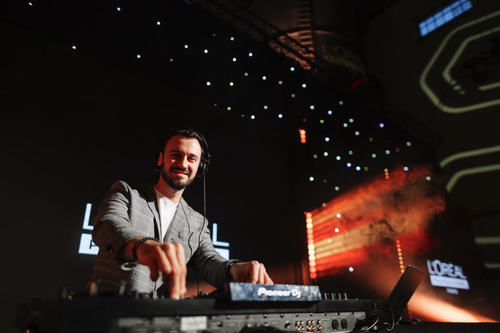 DJ Bury playing at a corporate event with an LED screen and light show – DJ for events in Brno