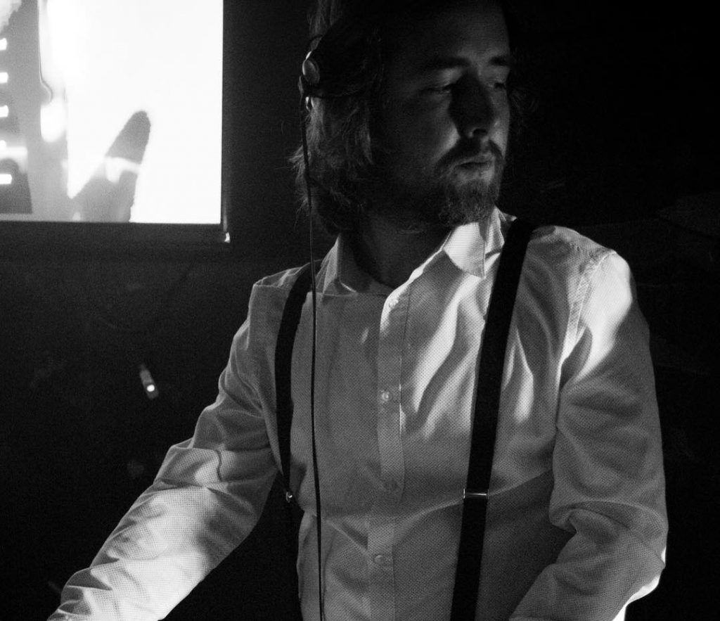 Black-and-white photo of DJ Michal Pešina behind the decks – Michal Pešina