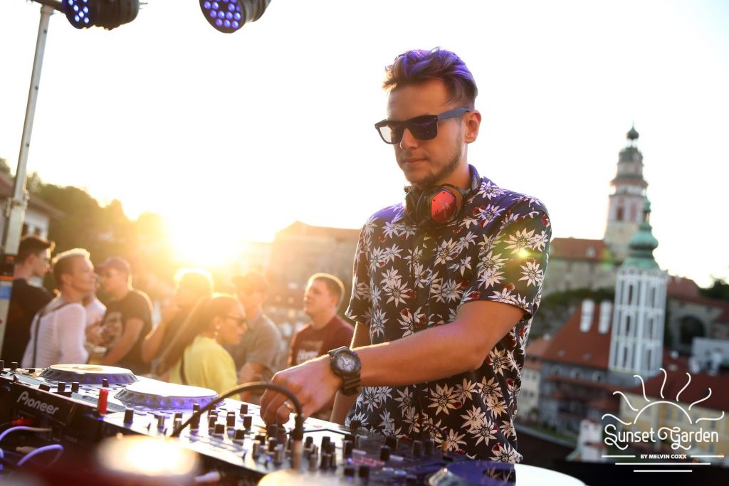 DJ Václav Brom playing at an outdoor summer event with a historic tower in the background – DJ for events in Ostrava