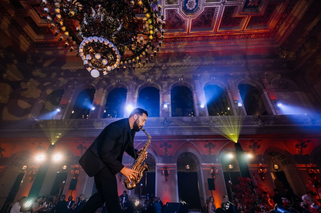 Saxophonist Johny Sax playing on stage in a historic hall at the Art of Beauty event