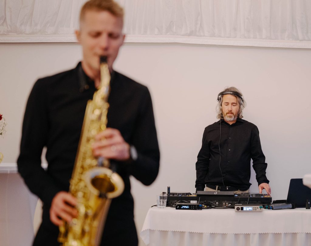 DJ Michal Pešina and saxophonist DeeSaxx playing at a corporate summer party in Bratislava