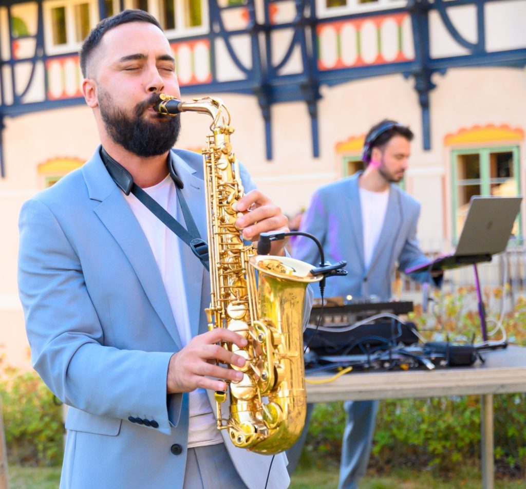 Saxophonist Johny Sax playing with a DJ at an outdoor corporate event